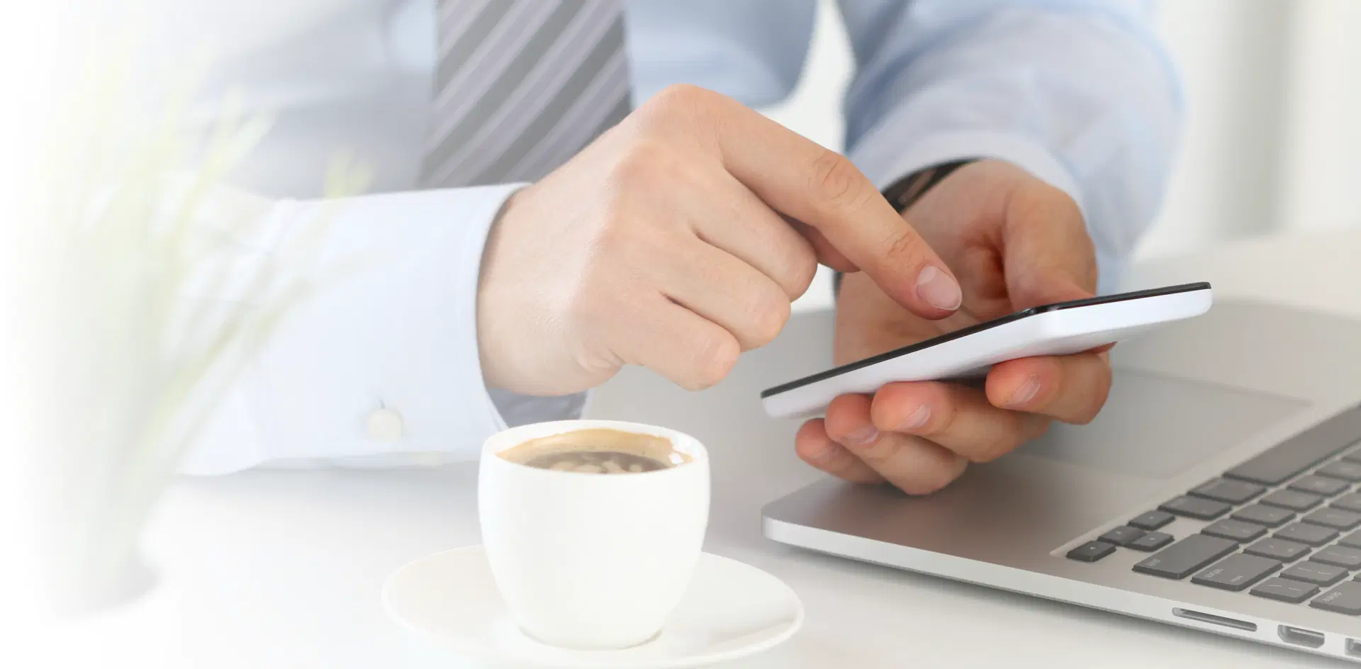 Close-up view of a man's hands holding a smartphone.